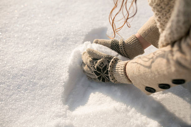 Young woman picking up snow; cut out